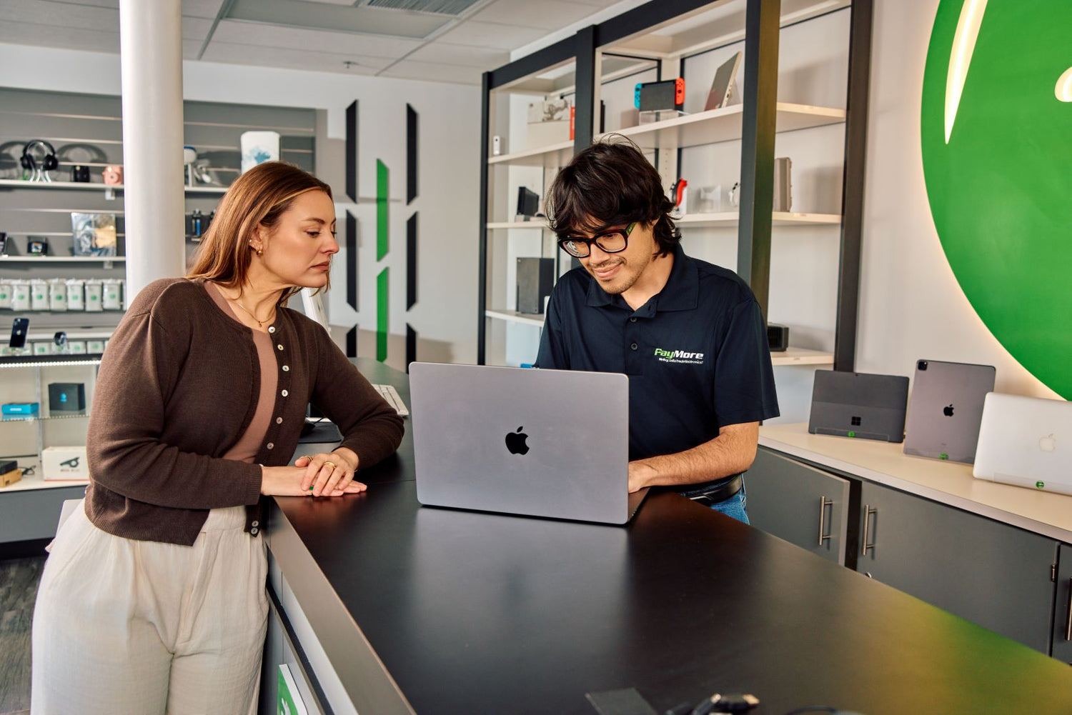employee inspecting a laptop